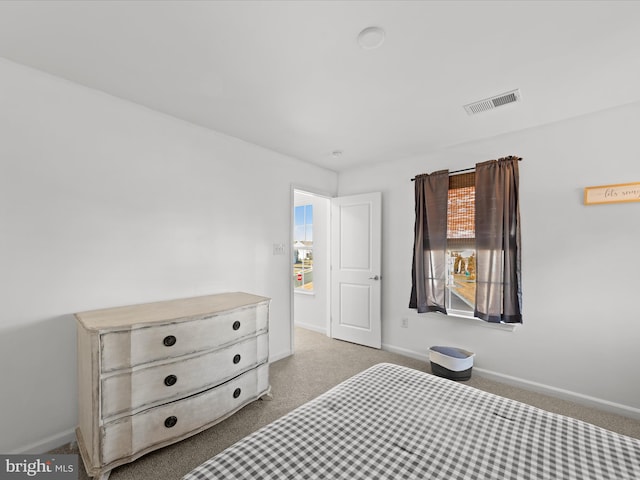 bedroom with light colored carpet