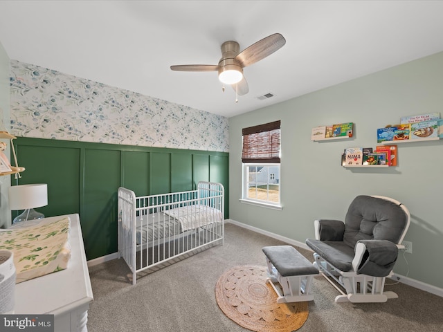 carpeted bedroom with a nursery area