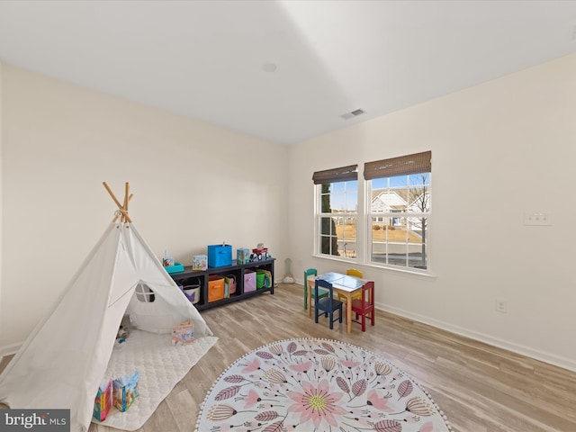 rec room with light hardwood / wood-style flooring