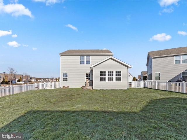 rear view of property with a yard