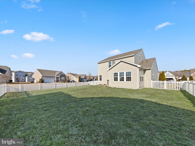 rear view of house with a yard