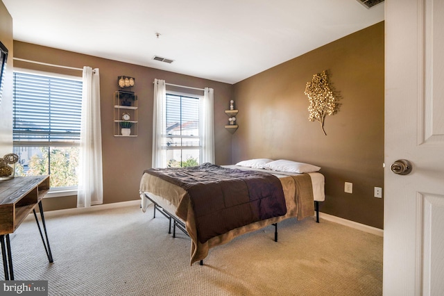 carpeted bedroom featuring multiple windows