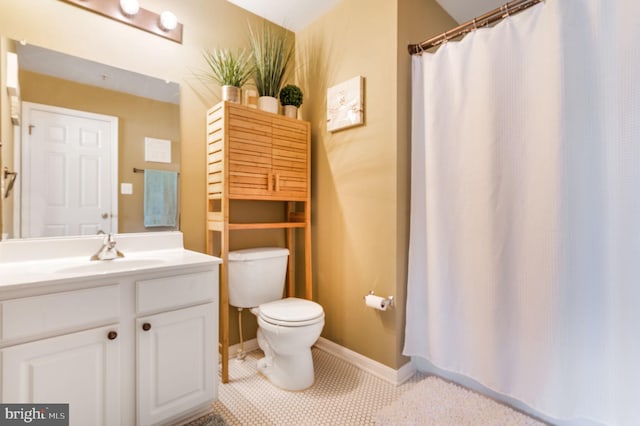 bathroom with vanity, tile patterned floors, and toilet