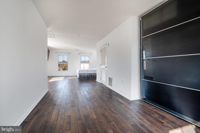 corridor featuring dark wood-type flooring