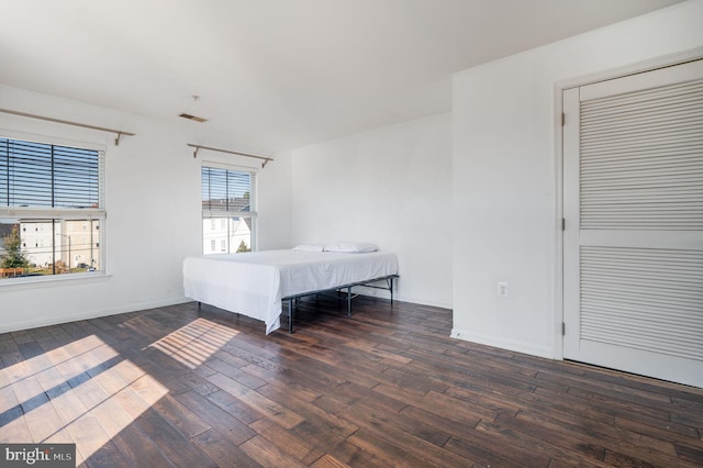 unfurnished bedroom with dark hardwood / wood-style floors