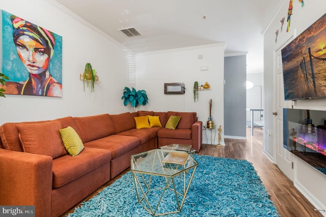 living room with hardwood / wood-style floors and ornamental molding