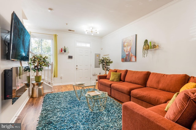 living room with wood-type flooring and ornamental molding