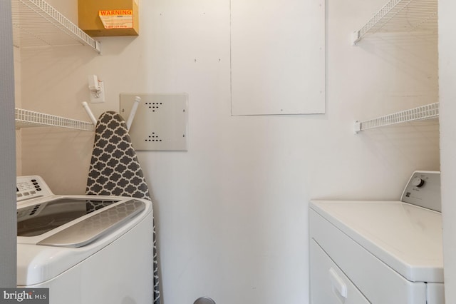 laundry room with washing machine and clothes dryer