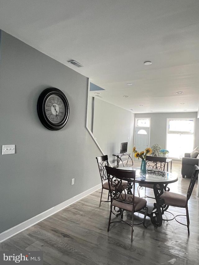 dining space with dark hardwood / wood-style floors