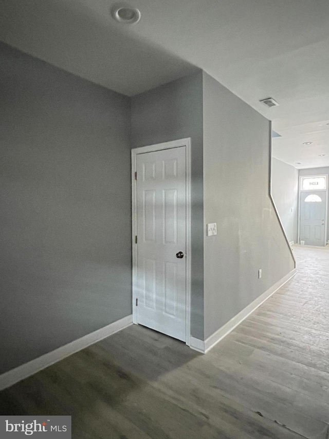 corridor featuring wood-type flooring