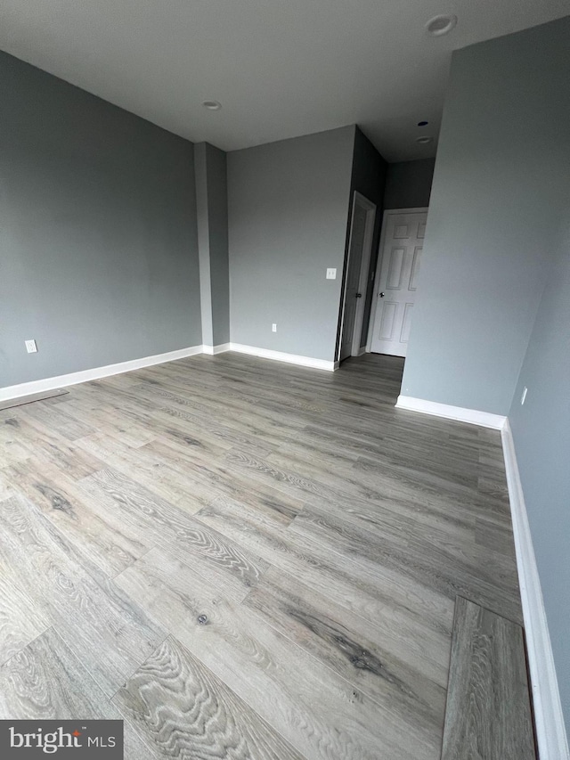 spare room featuring wood-type flooring