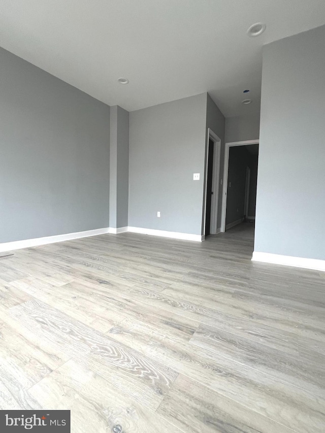 unfurnished room with light hardwood / wood-style flooring