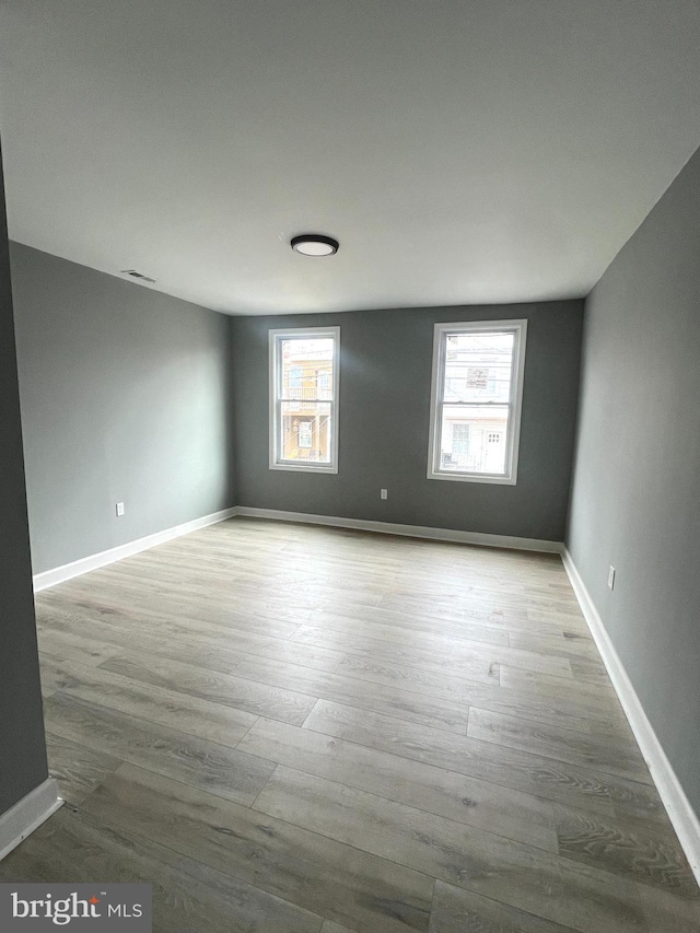 empty room with light hardwood / wood-style floors