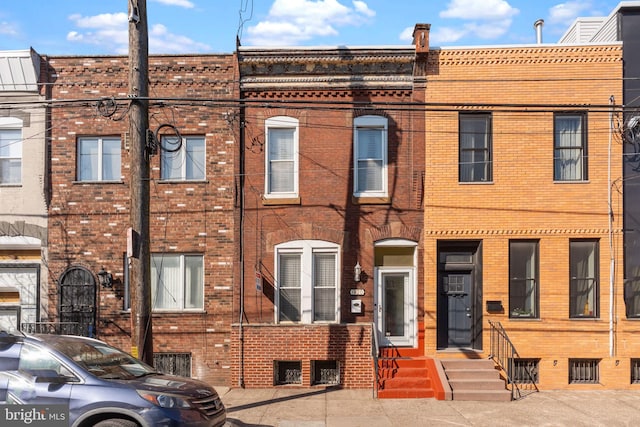 multi unit property featuring entry steps and brick siding