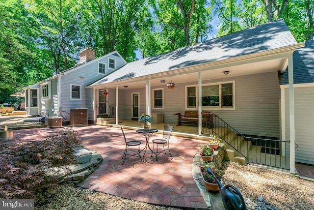 rear view of house with cooling unit and a patio