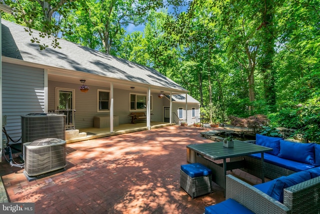 view of patio / terrace with an outdoor living space and central air condition unit