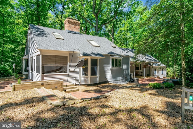 view of front of house featuring a sunroom