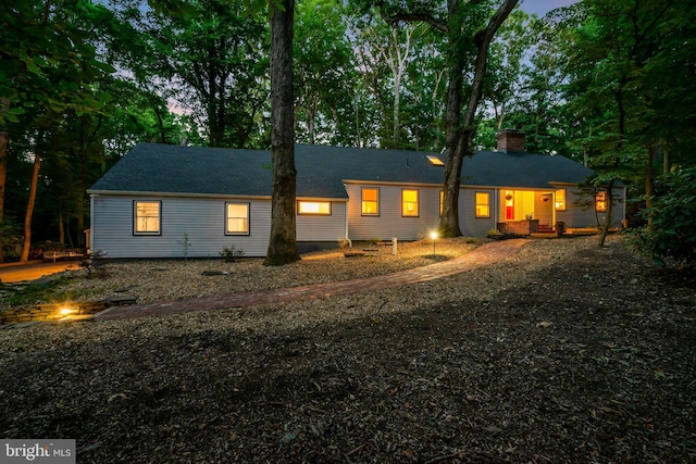 view of back house at dusk