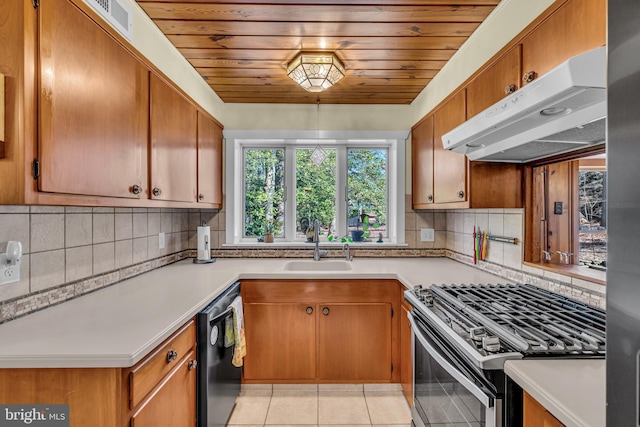 kitchen featuring sink, stainless steel gas range oven, light tile patterned floors, dishwashing machine, and backsplash