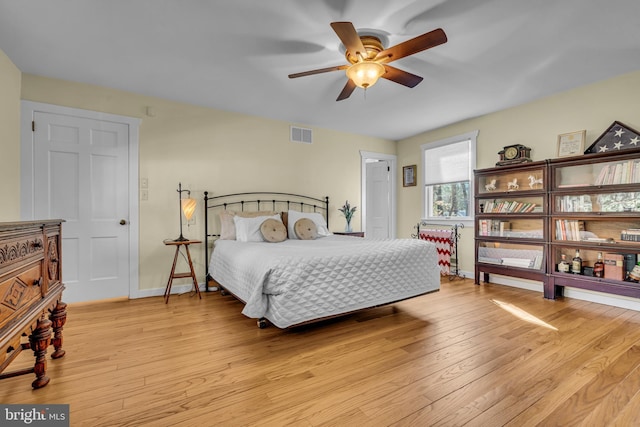 bedroom with ceiling fan and light hardwood / wood-style floors