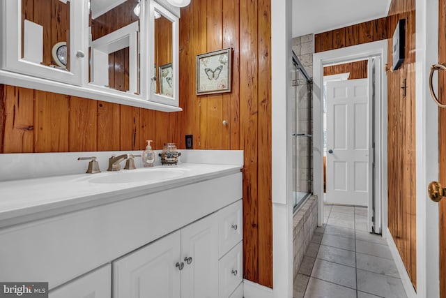 bathroom with vanity, tile patterned floors, and wood walls