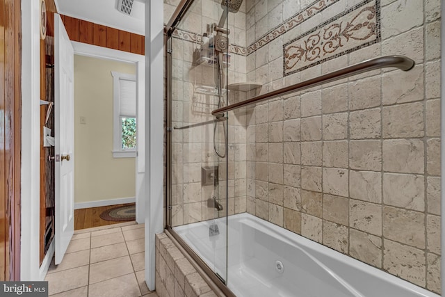 bathroom featuring tile patterned floors and combined bath / shower with glass door