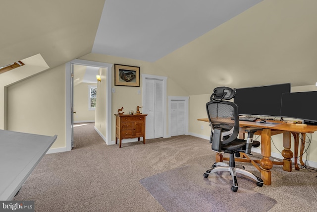 carpeted office space featuring vaulted ceiling