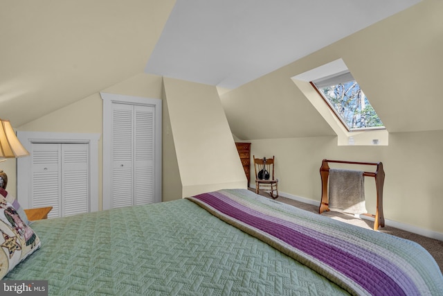 carpeted bedroom with vaulted ceiling with skylight