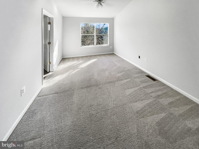 carpeted spare room with ceiling fan