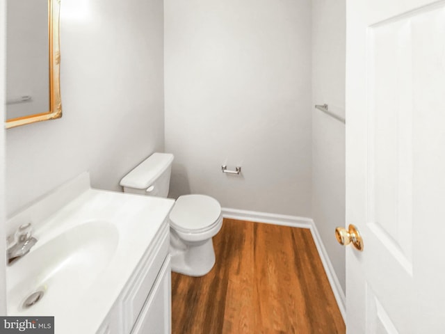 bathroom featuring hardwood / wood-style flooring, vanity, and toilet