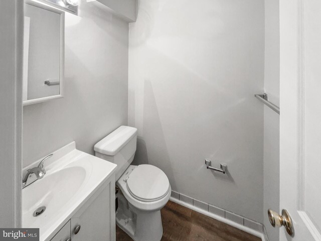 bathroom featuring vanity, hardwood / wood-style floors, and toilet