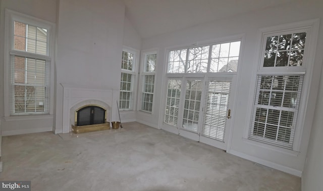 unfurnished living room with light carpet, a fireplace, and vaulted ceiling