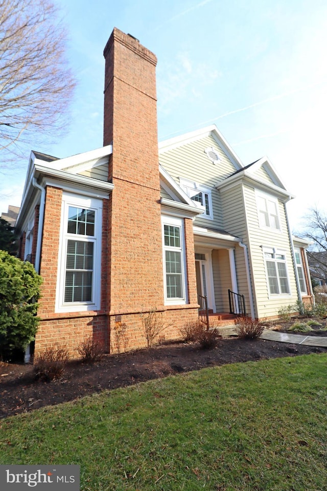 view of property exterior with a lawn