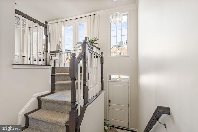 stairway with a healthy amount of sunlight and french doors