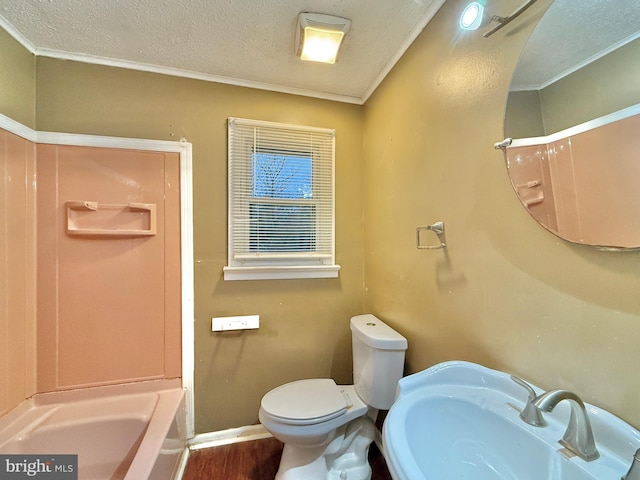 bathroom featuring sink, hardwood / wood-style flooring, toilet, crown molding, and a textured ceiling