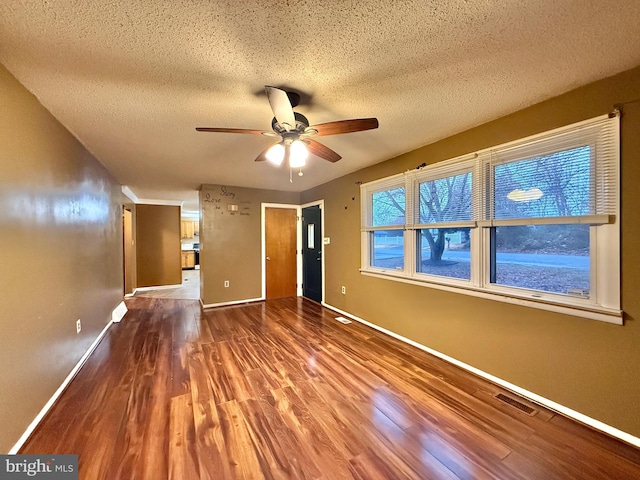 spare room with ceiling fan, hardwood / wood-style floors, and a textured ceiling