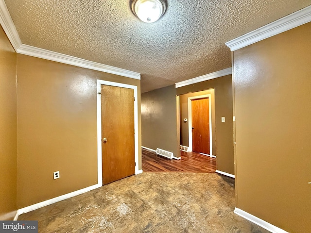 unfurnished room featuring crown molding and a textured ceiling