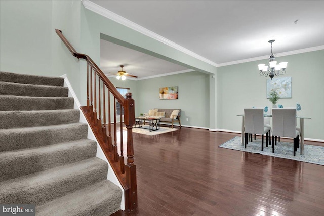 interior space with wood-type flooring, ceiling fan with notable chandelier, and crown molding