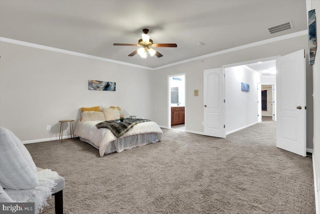 carpeted bedroom featuring ceiling fan, ensuite bath, and ornamental molding