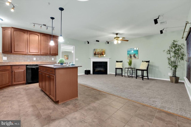 kitchen with black dishwasher, decorative backsplash, a kitchen island, light carpet, and decorative light fixtures