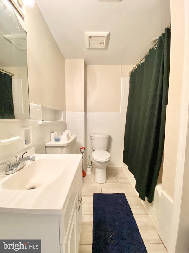 full bathroom featuring vanity, tile walls, shower / tub combo, and toilet