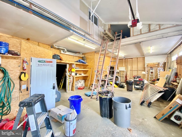 garage with a garage door opener and a workshop area