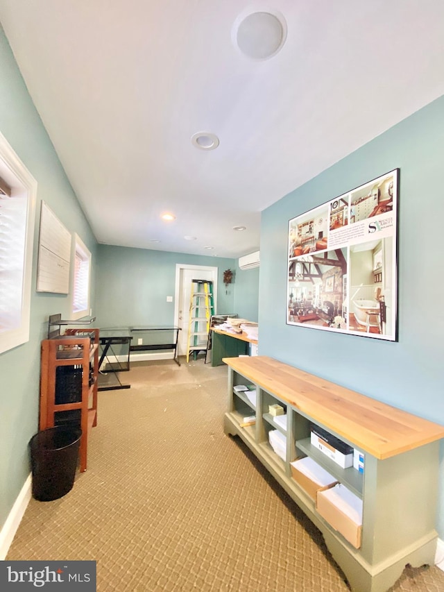 hallway featuring a wall mounted AC and light carpet