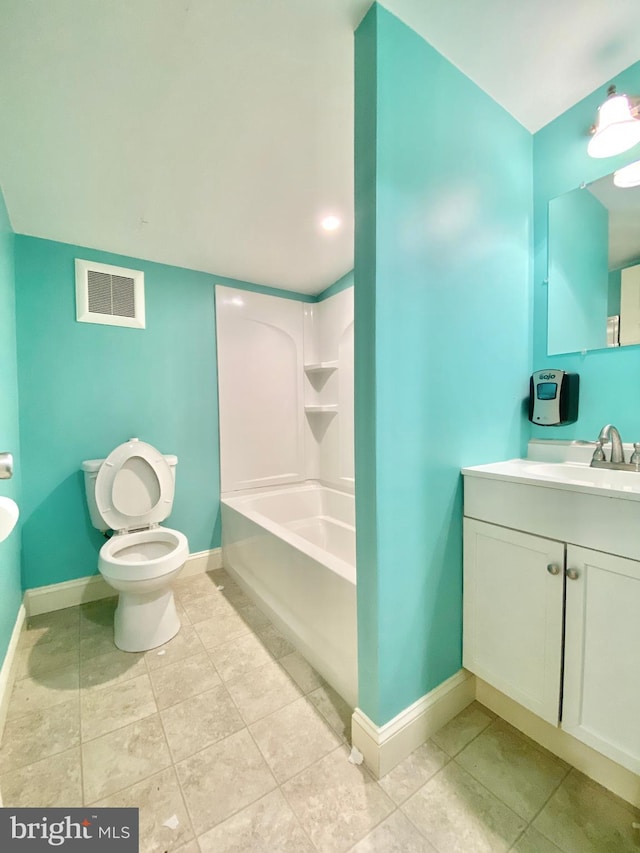 bathroom with tile patterned floors, a tub to relax in, toilet, and vanity