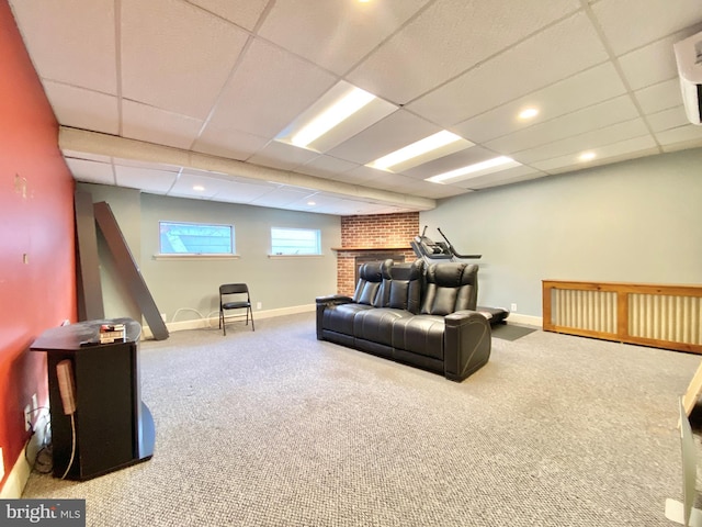 living room featuring a brick fireplace, carpet flooring, and a paneled ceiling