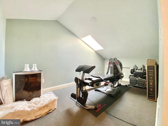 exercise area with lofted ceiling with skylight