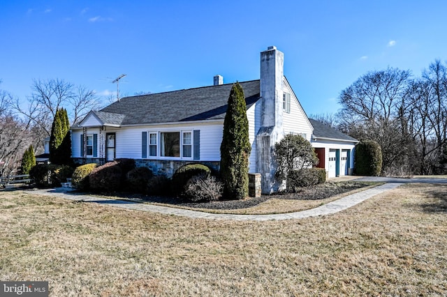 view of side of property with a garage and a lawn