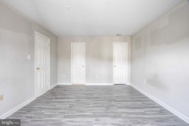 spare room with light hardwood / wood-style flooring