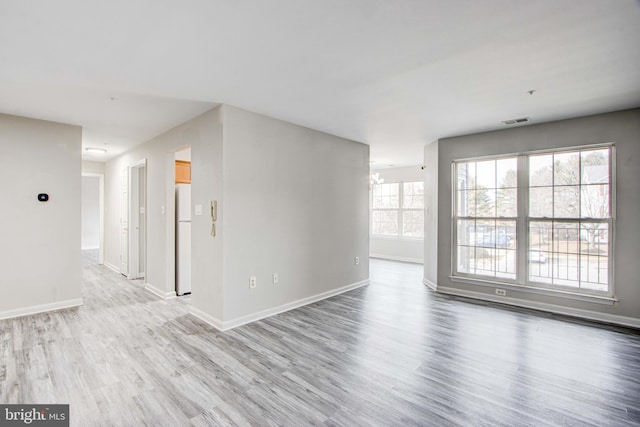 spare room with light hardwood / wood-style floors