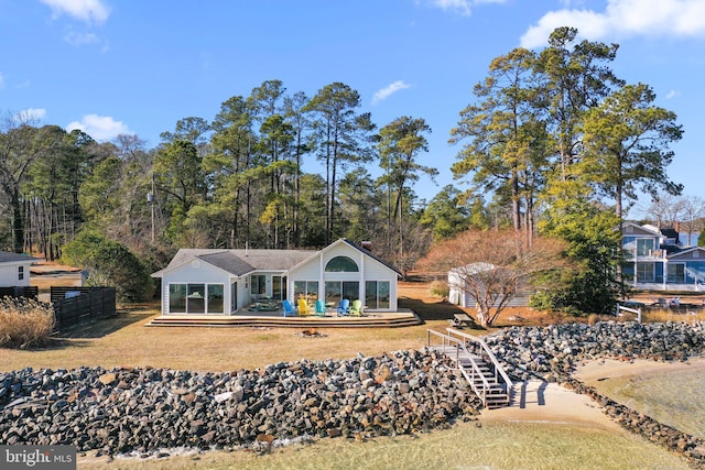 rear view of house featuring a lawn